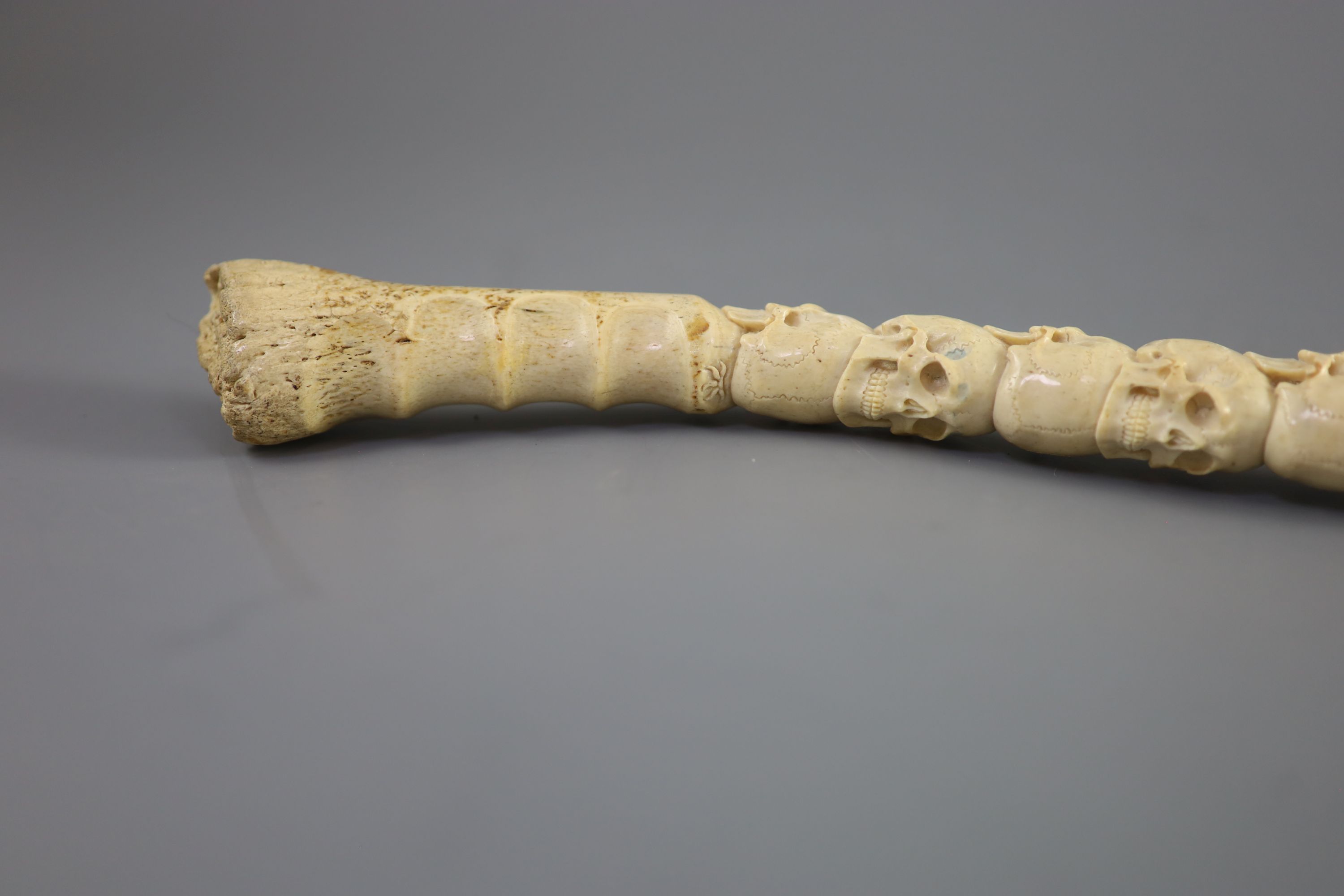 A unusual Inuit ‘skull’ carved walrus baculum, believed to be 19th century, 49.5 cm long